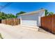 Detached garage with a large door and ample driveway space, ideal for vehicle storage and home projects at 1748 W Tennessee Ave, Denver, CO 80223