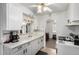Charming kitchen features white cabinets, ample counter space, and view into the living area at 1748 W Tennessee Ave, Denver, CO 80223