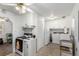 Combined Kitchen and Laundry Room featuring white appliances and cabinets at 1748 W Tennessee Ave, Denver, CO 80223