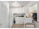Efficient laundry room with washer, dryer, refrigerator, and storage cabinets at 1748 W Tennessee Ave, Denver, CO 80223