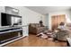 Comfortable living area with hardwood flooring, decorative fireplace, and neutral-toned furniture at 1748 W Tennessee Ave, Denver, CO 80223