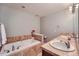 Relaxing bathroom showcasing a soaking tub with mosaic tile and double sinks with plenty of counterspace at 467 S Reed Ct, Lakewood, CO 80226
