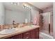 Bright bathroom featuring double sinks, a large mirror, and a separate shower, perfect for a modern lifestyle at 467 S Reed Ct, Lakewood, CO 80226