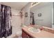 Cozy bathroom featuring a shower-tub combo, decorative shower curtain and neutral color scheme at 467 S Reed Ct, Lakewood, CO 80226