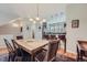 Elegant dining space with modern lighting, wooden table, and view of kitchen at 467 S Reed Ct, Lakewood, CO 80226