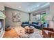Stylish living room with hardwood floors, comfortable blue sofa, and modern decor at 467 S Reed Ct, Lakewood, CO 80226