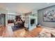 Open-concept living space with hardwood floors, dining area, and modern kitchen at 467 S Reed Ct, Lakewood, CO 80226