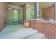 Inviting front porch with brick accents, a green door, and a potted plant at 467 S Reed Ct, Lakewood, CO 80226