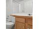 Bathroom with a tub, shower, white tile and wood-look vanity at 11237 W 55Th Ln, Arvada, CO 80002