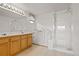 Bathroom with walk-in tub, double vanity and glass shower door at 11237 W 55Th Ln, Arvada, CO 80002