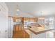 Bright kitchen with light wood cabinets, tile countertops, hardwood floors, and a charming chandelier, perfect for cooking at 11237 W 55Th Ln, Arvada, CO 80002