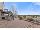 Brick patio overlooking golf course and pond with a staircase to upper level at 11237 W 55Th Ln, Arvada, CO 80002