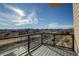 Balcony with clear glass railing and view of railroad tracks, walking path, and mountains beyond at 1208 N Quitman St # 402, Denver, CO 80204