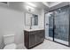 Modern bathroom with sleek vanity, framed mirror, and a glass-enclosed shower at 1208 N Quitman St # 402, Denver, CO 80204