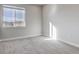 Sun-filled bedroom with neutral carpet and a bright window overlooking the landscape at 1208 N Quitman St # 402, Denver, CO 80204