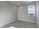 This carpeted bedroom has neutral walls, white trim, and a window to let in natural light at 1208 N Quitman St # 402, Denver, CO 80204