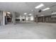 An expansive garage with concrete pillars, overhead lighting, and ample parking space at 1208 N Quitman St # 402, Denver, CO 80204