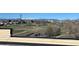 Scenic view from rooftop featuring lush trees, walking path, and snow-capped mountains at 1208 N Quitman St # 402, Denver, CO 80204