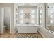 Freestanding tub under decorative windows with a separate shower and toilet room at 16231 Thunder Cat Way, Monument, CO 80132