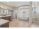 Bathroom with a soaking tub, walk-in shower, and wood-look flooring at 16231 Thunder Cat Way, Monument, CO 80132