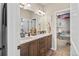 Stylish bathroom with double vanity, wood cabinets, and modern fixtures at 16231 Thunder Cat Way, Monument, CO 80132