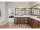 Bathroom vanity with double mirrors and wood cabinets, with views into the bedroom at 16231 Thunder Cat Way, Monument, CO 80132