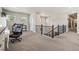 Spacious hallway with view of staircase features a dedicated workspace with windows for natural light at 16231 Thunder Cat Way, Monument, CO 80132
