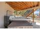 Outdoor hot tub features covered seating and a view of the surrounding yard and trees at 16231 Thunder Cat Way, Monument, CO 80132