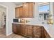 Butler's pantry with wooden cabinets, light countertops, and stainless steel microwave at 16231 Thunder Cat Way, Monument, CO 80132