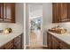 Pass through kitchen featuring ample storage with views of the dining room and exterior at 16231 Thunder Cat Way, Monument, CO 80132