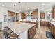 Spacious kitchen featuring a large island with stool seating and stainless steel appliances at 16231 Thunder Cat Way, Monument, CO 80132