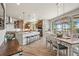 Eat-in kitchen features an island with bar seating, stainless steel appliances and wooden cabinets at 16231 Thunder Cat Way, Monument, CO 80132