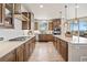Galley style kitchen with stainless steel appliances, light countertops and dark wood cabinets at 16231 Thunder Cat Way, Monument, CO 80132