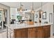 Bright kitchen with large island, quartz countertops, and pendant lighting, flowing into the living room at 16231 Thunder Cat Way, Monument, CO 80132