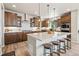Kitchen island with pendant lighting, light countertops, stainless appliances, and dark wood cabinets at 16231 Thunder Cat Way, Monument, CO 80132