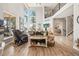 Open-concept living room showcasing wood floors, tall windows and stairs to the second floor at 16231 Thunder Cat Way, Monument, CO 80132
