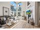 Bright living room with tall windows, fireplace and wood floors at 16231 Thunder Cat Way, Monument, CO 80132