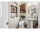 Charming powder room with pedestal sink, wood accents, and decorative wall art at 16231 Thunder Cat Way, Monument, CO 80132