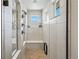 Walk-in shower with tiled walls, a built-in bench, and glass door at 16231 Thunder Cat Way, Monument, CO 80132