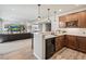Modern wet bar features custom wood cabinets, quartz countertops, and a beverage fridge at 16231 Thunder Cat Way, Monument, CO 80132