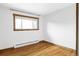 Neutral room with hardwood floors, window and wood trim, ready for personalization at 1908 Taft Dr, Lakewood, CO 80215
