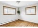 Bright bedroom with hardwood floors, dual windows offering natural light and warm wood trim at 1908 Taft Dr, Lakewood, CO 80215