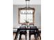 Close up on dining room table with a wooden table, six chairs, and natural light at 1908 Taft Dr, Lakewood, CO 80215