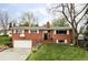 Classic brick home with a well-maintained lawn, attached garage, and traditional architectural details at 1908 Taft Dr, Lakewood, CO 80215