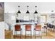 Modern kitchen with stainless steel appliances, granite countertops, and a stylish breakfast bar area at 1908 Taft Dr, Lakewood, CO 80215