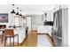 Bright kitchen with stainless steel appliances, modern cabinetry, and an island with barstool seating at 1908 Taft Dr, Lakewood, CO 80215