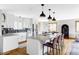 Bright, modern kitchen with stainless steel appliances, island with seating, and granite countertops at 1908 Taft Dr, Lakewood, CO 80215