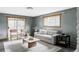 View of the living room with gray sofa, wood trim, black accents, and a sliding door to the yard at 1908 Taft Dr, Lakewood, CO 80215