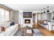 Inviting living room with hardwood floors, fireplace and bright, natural light from the large windows at 1908 Taft Dr, Lakewood, CO 80215
