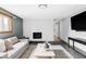 Spacious living room featuring fireplace, a gray sofa, and large screen TV at 1908 Taft Dr, Lakewood, CO 80215